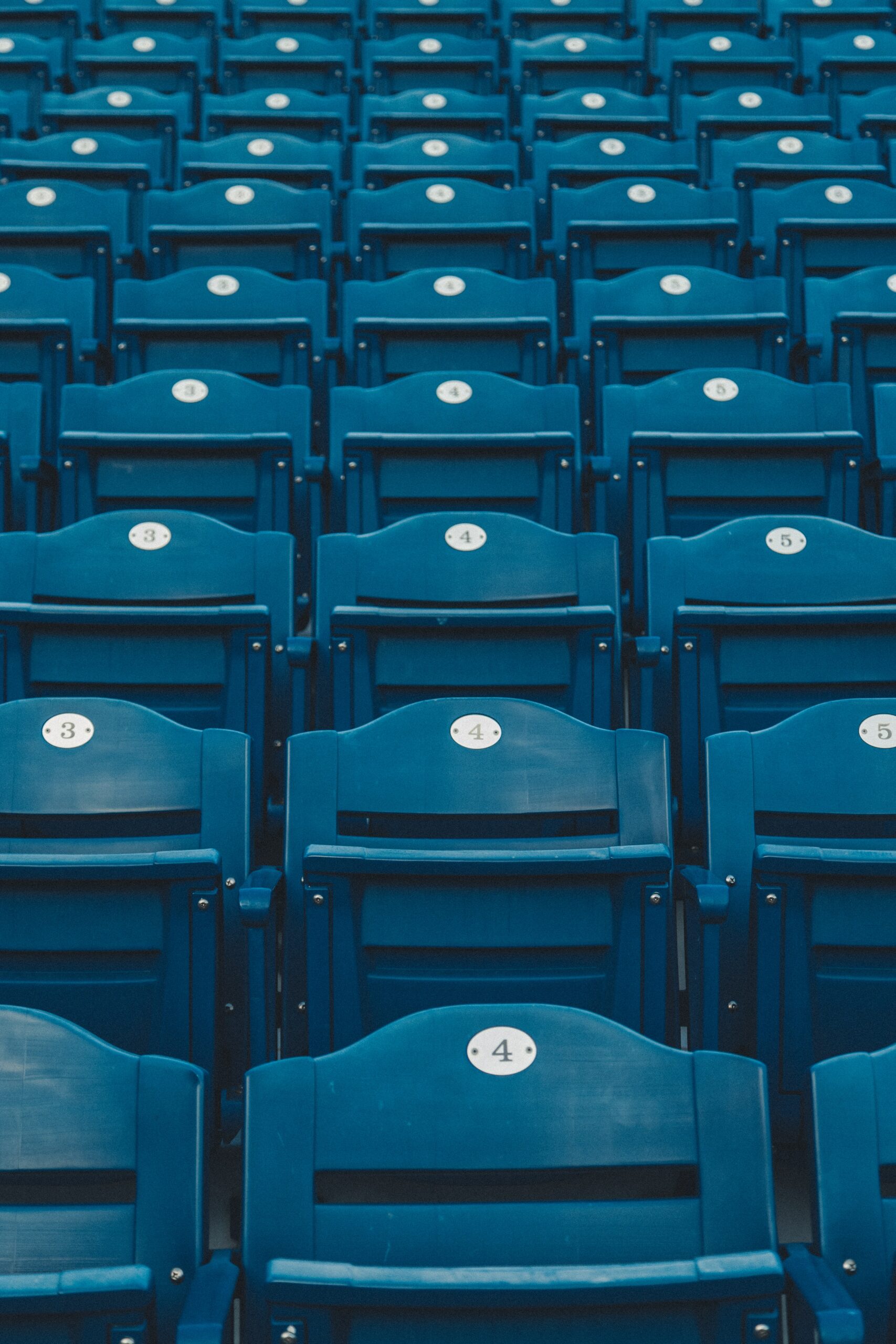 Rows of empty numbered seats at a sports stadium